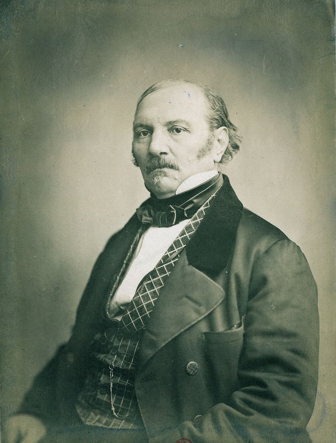 19th-century photographic portrait of Allan Kardec, seated in a dark suit.
